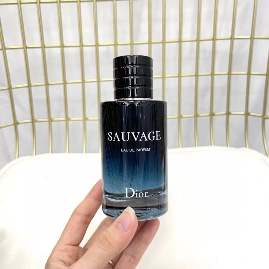 Dior Sauvage EDP 100ml bottle held in hand front view
