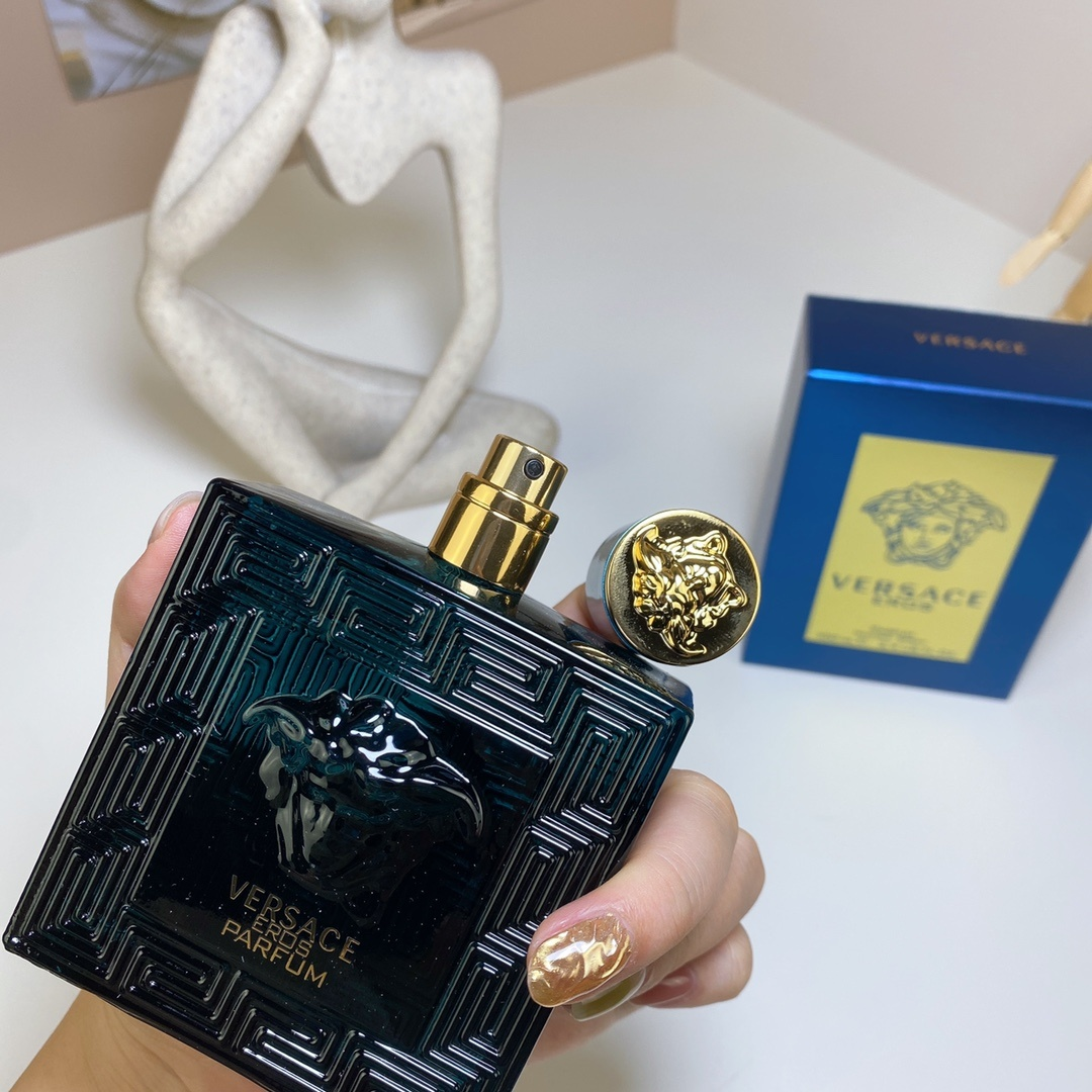 Versace Eros Parfum 100ml bottle held in hand