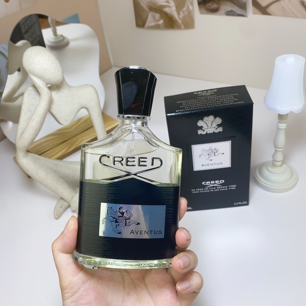 Creed Aventus EDP 100ml bottle held with box
