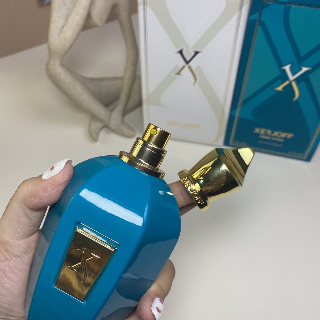 Xerjoff Erba Pura EDP 100ml bottle held in hand with box