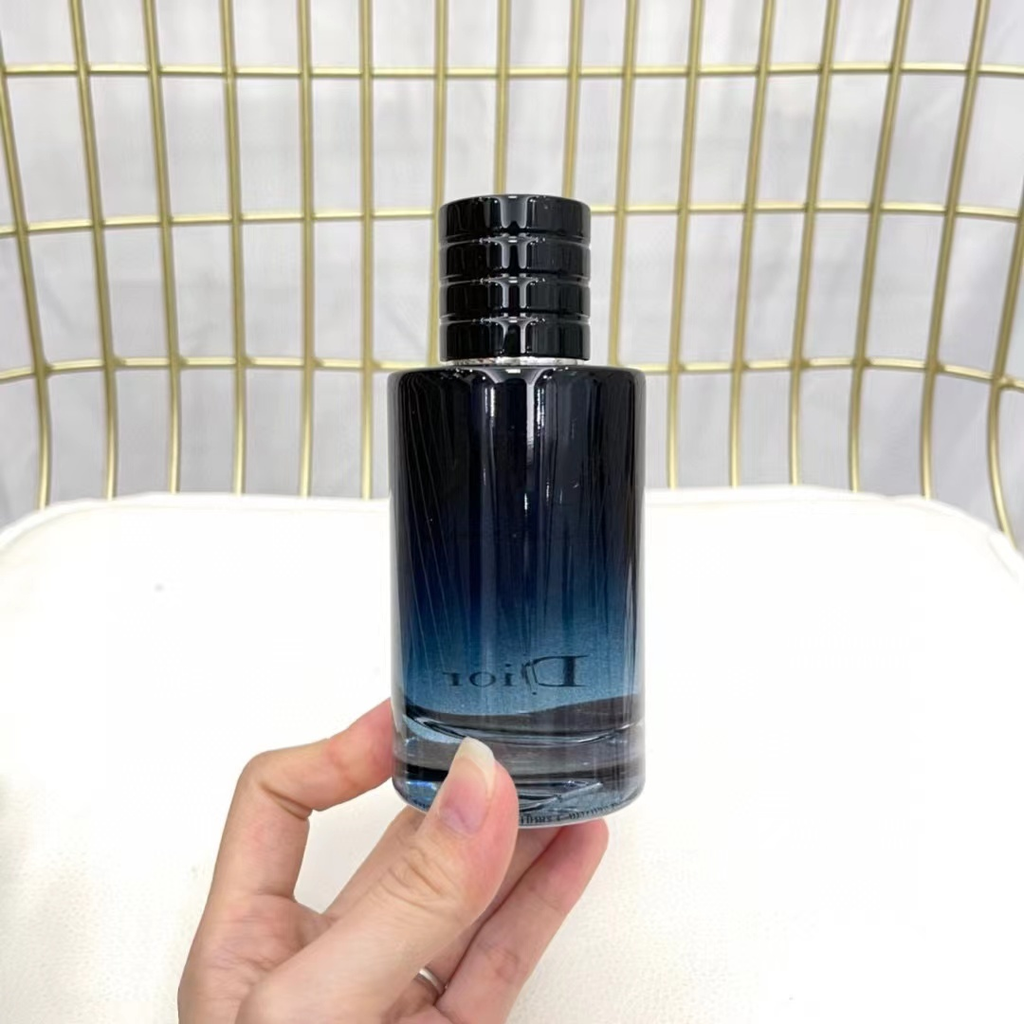 Dior Sauvage EDP 100ml bottle held in hand back view